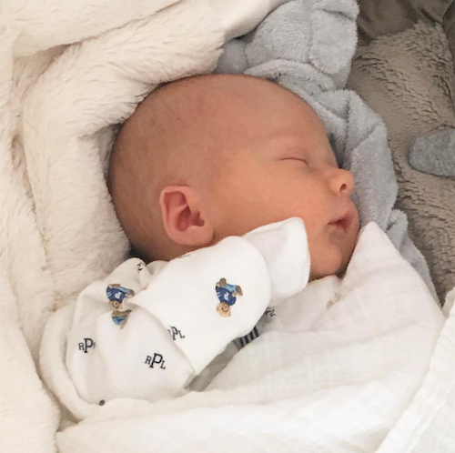 Alec Baldwin's baby wrapped in Little Giraffe baby blanket