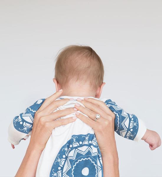 Baby wearing Airie™ Compass baby gown in denim