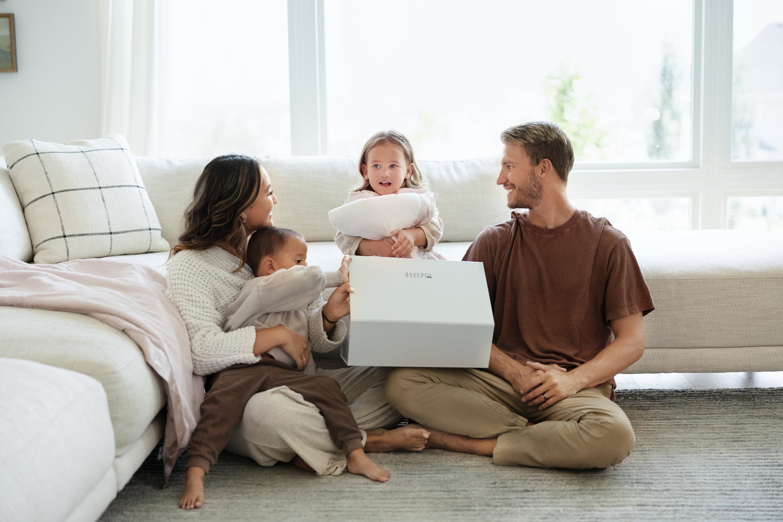 family gifting their kid a soft blanket