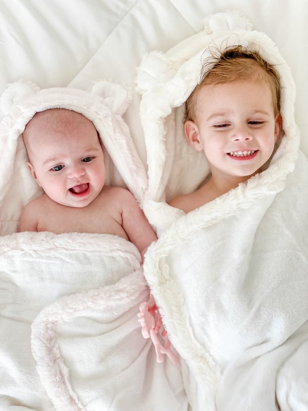 Baby & toddler smiling wrapped in baby towels